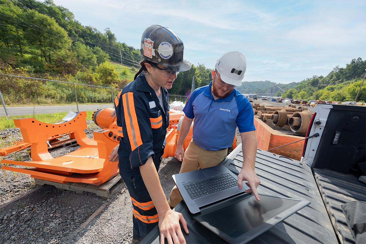 Workers looking at a laptop
