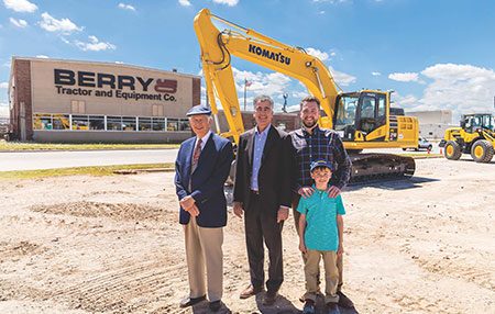 Four generations of the Berry family in front of a Berry tractor facility