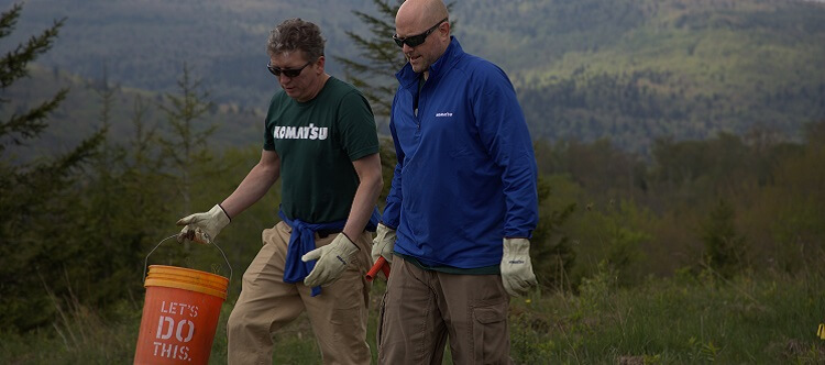 Komatsu executives planting trees in Appalachia