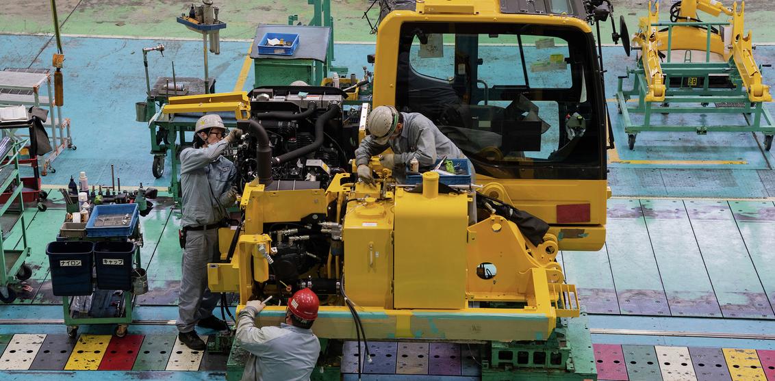 Komatsu employees assemble a PC series hydraulic excavator