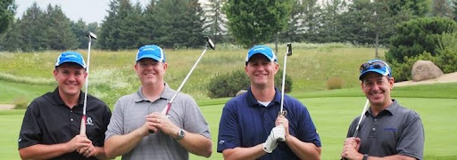 Four Komatsu employees at golf fundraising event