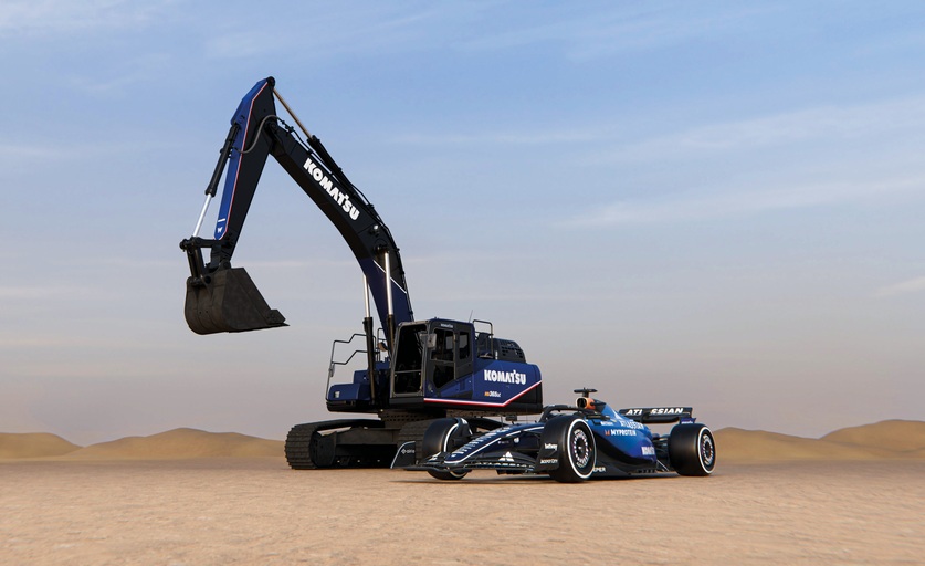 a komatsu excavator next to a racing car