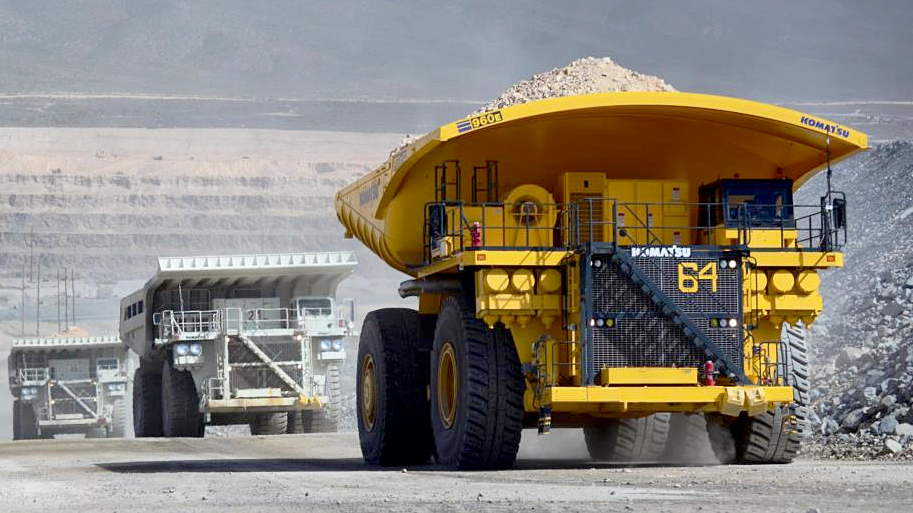 A Komatsu 960E electric mining truck with a DT Hi-Load truck body hauling material in a surface mine.