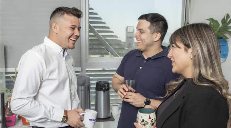 Yerko Andres Arce Alvial chats with colleagues at the Santiago headquarters of Komatsu Cummins Chile.